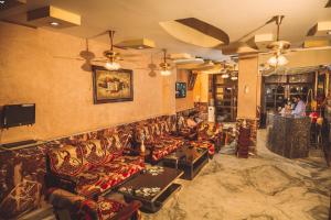 a living room with couches and a wall with at Hotel Meenakshi Udaipur - Family Preffered Hotel in Udaipur