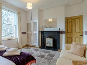 a living room with a fireplace and a couch at 6 Bed in Richmond 6mls 52779 in Catterick Bridge