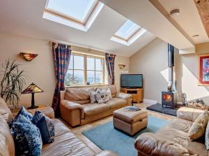 a living room with a couch and a tv at 3 Bed in Conwy 74146 in Eglwys-Fâch