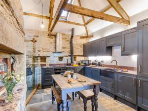 a kitchen with blue cabinets and a wooden table at 2 Bed in Allendale 78158 in Catton