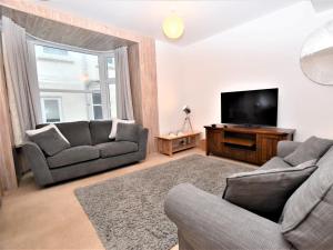a living room with two couches and a flat screen tv at 3 Bed in Ilfracombe 66239 in Ilfracombe