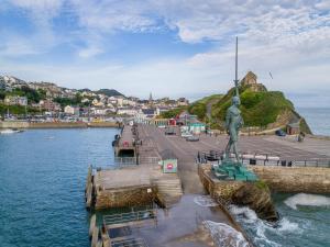 a statue on a pier next to a body of water at 3 Bed in Ilfracombe 66239 in Ilfracombe