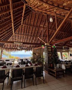 a restaurant with tables and chairs and a view of the ocean at Tanna Evergreen Resort & Tours in Tanna Island