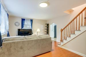 a living room with a couch and a staircase at Pet-Friendly Burlington Home 17 Mi to Boston! in Burlington