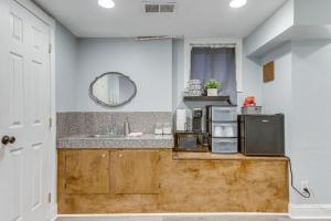 a kitchen with a sink and a counter with a microwave at 1 Mi to Coors Field Cozy Denver Studio with Patio! in Denver +16 photos
