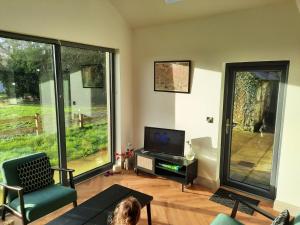 a living room with a large window and a tv at Corradiller Quay, Lisnaskea, Fermanagh in Lisnaskea