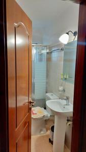 a bathroom with a sink and a toilet at Allotino Hotel - Café & snacks in Stavrodhrómion