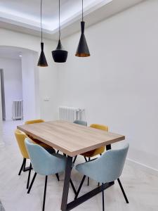 a dining room with a wooden table and chairs at Apartamento Domus in Teruel +11 photos