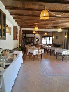 a large dining room with tables and chairs and lights at Allotino Hotel - Café & snacks in Stavrodhrómion