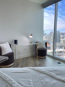 a bedroom with a bed and a view of a city at Extraordinary Escape with Rooftop Pool 2 in San Diego