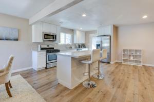 a kitchen with white cabinets and stainless steel appliances at Escondido Vacation Rental about 1 Mi to Grape Day Park in Escondido