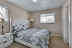 a bedroom with a bed and two windows at Escondido Vacation Rental about 1 Mi to Grape Day Park in Escondido