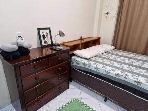 a small bedroom with a bed and a dresser at Apartamento inteiro em condomínio in Rio Branco