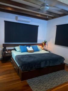 a bedroom with a large bed with blue pillows at Casa Gato in Big Creek