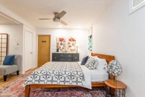 a bedroom with a bed and a ceiling fan at Cozy Private Apt near Downtown in Burlington