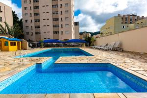 a swimming pool on the roof of a building at Hotel Excelsior in Poços de Caldas