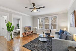 a living room with a couch and a ceiling fan at Elegant & Stylishly 1BR Fully Furnished Apt - Lincoln 205 in Chicago