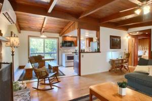 a living room with a couch and a table and a kitchen at Red Door Cottage Fireplace bbq 12 mi to Yosemite in Oakhurst