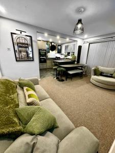 a living room with a couch and a dining room at Luxury Accommodation Denton in Denton
