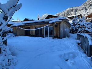 a cabin in the snow with a lot of snow at Out of the Box in Gsteig