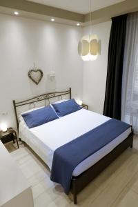 a bedroom with a large bed with blue sheets at Casa Fiorella in La Spezia