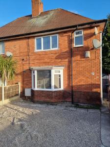 a brick house with a window on the side of it at Dulverton house - 3 bed house /sleeps 6+ driveway+close to M1 in Nottingham
