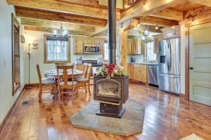 a kitchen and dining room with a woodburning stove at Happy Haven Hill Cabin with Patio and Fire Pit! in Dundee