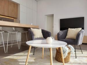 a living room with a table and two chairs at Firefly Luxury Apartment with private Whirlpool in Zadar +27 photos