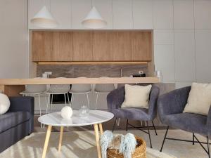a living room with chairs and a table at Firefly Luxury Apartment with private Whirlpool in Zadar