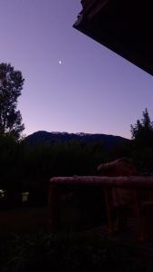 a view of the moon from the porch of a house at Espacio Aquarel Patagonia in Los Repollos