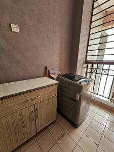 a kitchen with a trash can in the corner of a room at Globetrotter Condostay @ P11 in Putrajaya
