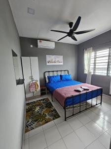 a bedroom with a bed and a ceiling fan at Globetrotter Condostay @ P11 in Putrajaya