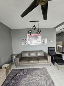 a living room with a couch and a table at Globetrotter Condostay @ P11 in Putrajaya