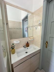 a bathroom with a sink and a mirror at Casas da Eva - Campolide in Lisbon
