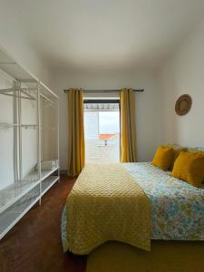 a bedroom with a bed and a window at Casas da Eva - Campolide in Lisbon