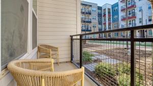 a balcony with two chairs and a balcony with condos at Landing Modern Apartment with Amazing Amenities (ID3691X72) in Austin