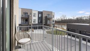 a chair sitting on the balcony of a building at Landing Modern Apartment with Amazing Amenities (ID5350X87) in Warrenville