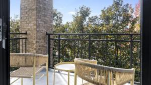 two chairs and a table on a balcony at Landing Modern Apartment with Amazing Amenities (ID1225X333) in Greenville