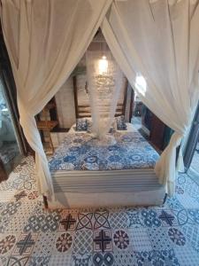 a bed with a canopy in a room at Mancora Apartments in Máncora