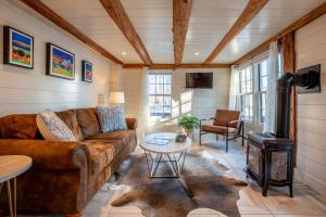 a living room with a couch and a wood stove at The Barnstead Inn in Manchester Center