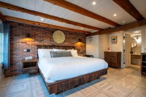 a bedroom with a bed and a brick wall at The Barnstead Inn in Manchester Center