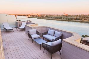 a balcony with chairs and a view of a river at Radisson Blu Hotel Rostov-on-Don in Rostov on Don