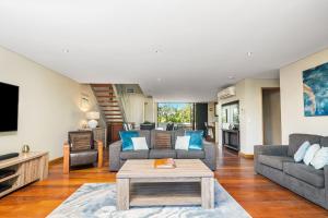 a living room with a couch and a table at Byron Bay Accom Unit 6 21-25 Fletcher Street - A Seventh Heaven in Byron Bay
