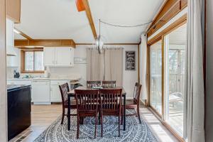 a kitchen with a dining room table and chairs at The Lost Bridge Lakehouse in Garfield