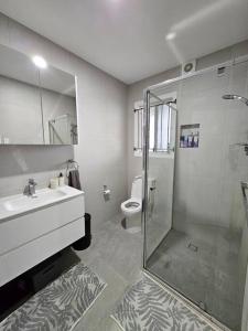 a bathroom with a shower and a sink and a toilet at Prime location: Just steps away from Oxford Street in Brisbane +37 photos