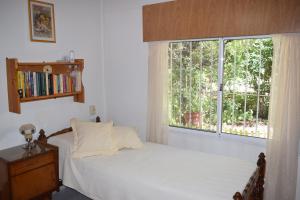 a bedroom with a bed and a large window at El sueño de Norma in San Antonio de Arredondo +7 photos