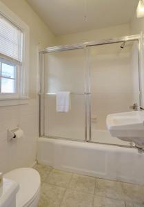 a bathroom with a shower and a toilet and a sink at Waves Oceanfront Resort in Old Orchard Beach