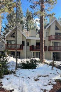 a large house with snow in front of it at Cozy & affordable, Spacious Condo by the lake in Incline Village