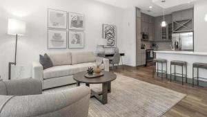 a living room with a couch and a table at Landing Modern Apartment with Amazing Amenities (ID5175X53) in Charlotte