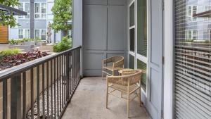two chairs sitting on the porch of a house at Landing Modern Apartment with Amazing Amenities (ID5175X53) in Charlotte